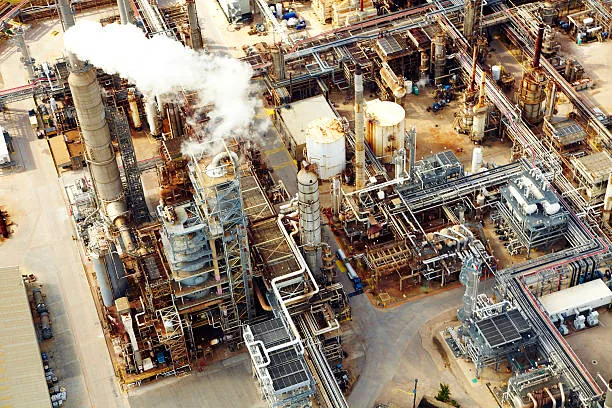 Aerial view of industrial columns, dense pipework and access roads